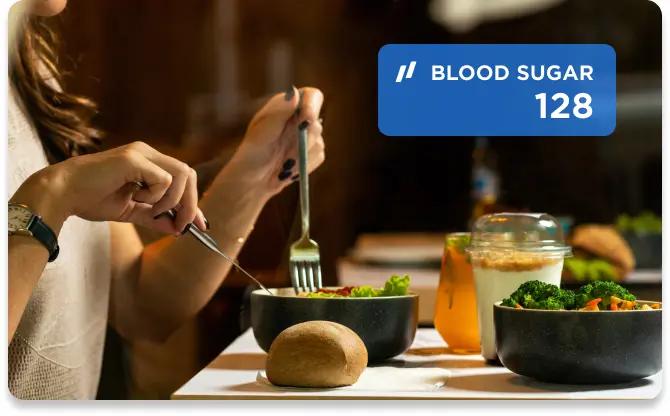 Woman eating a salad with her blood sugar showing